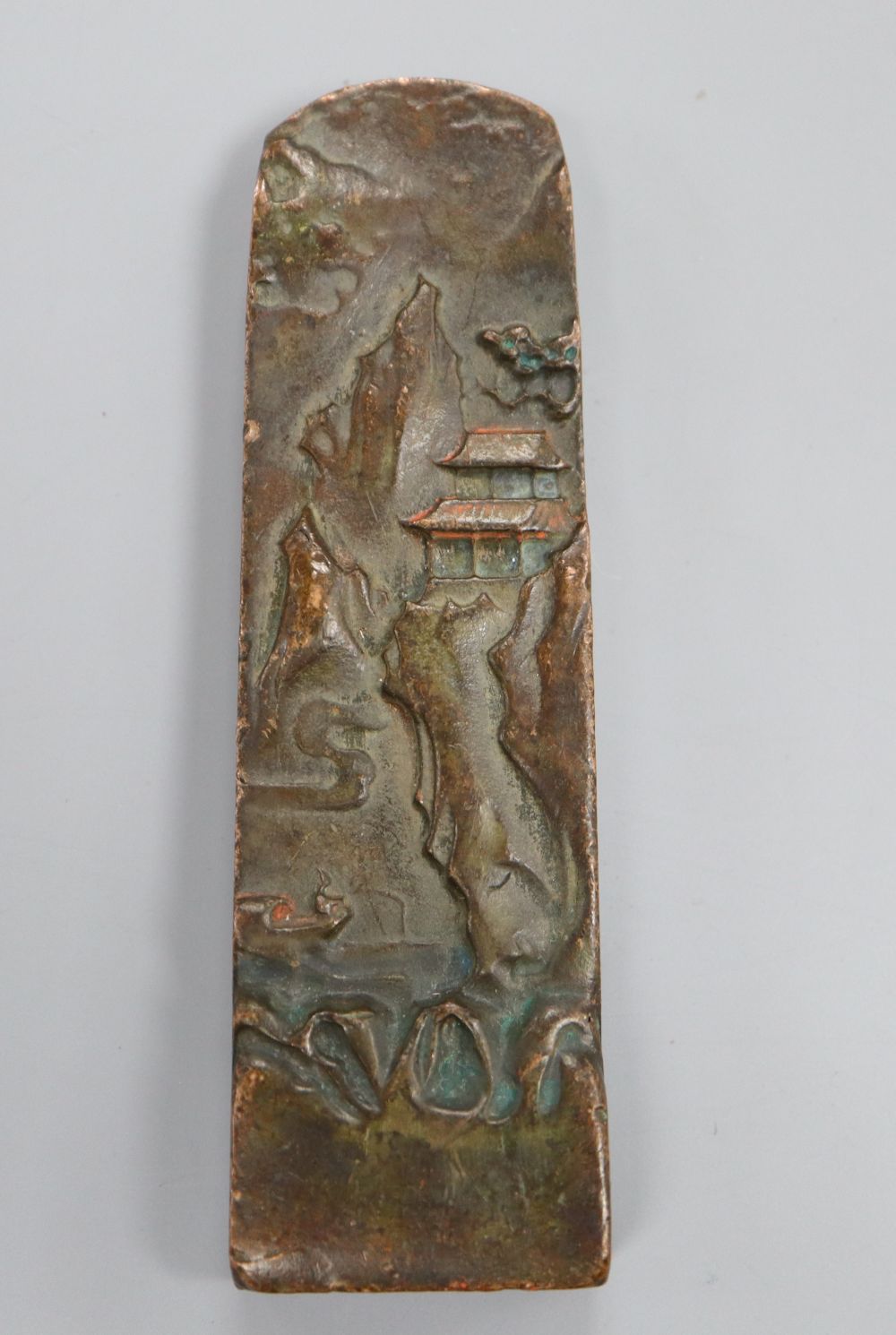 A Chinese bronze seal depicting a mountainous landscape